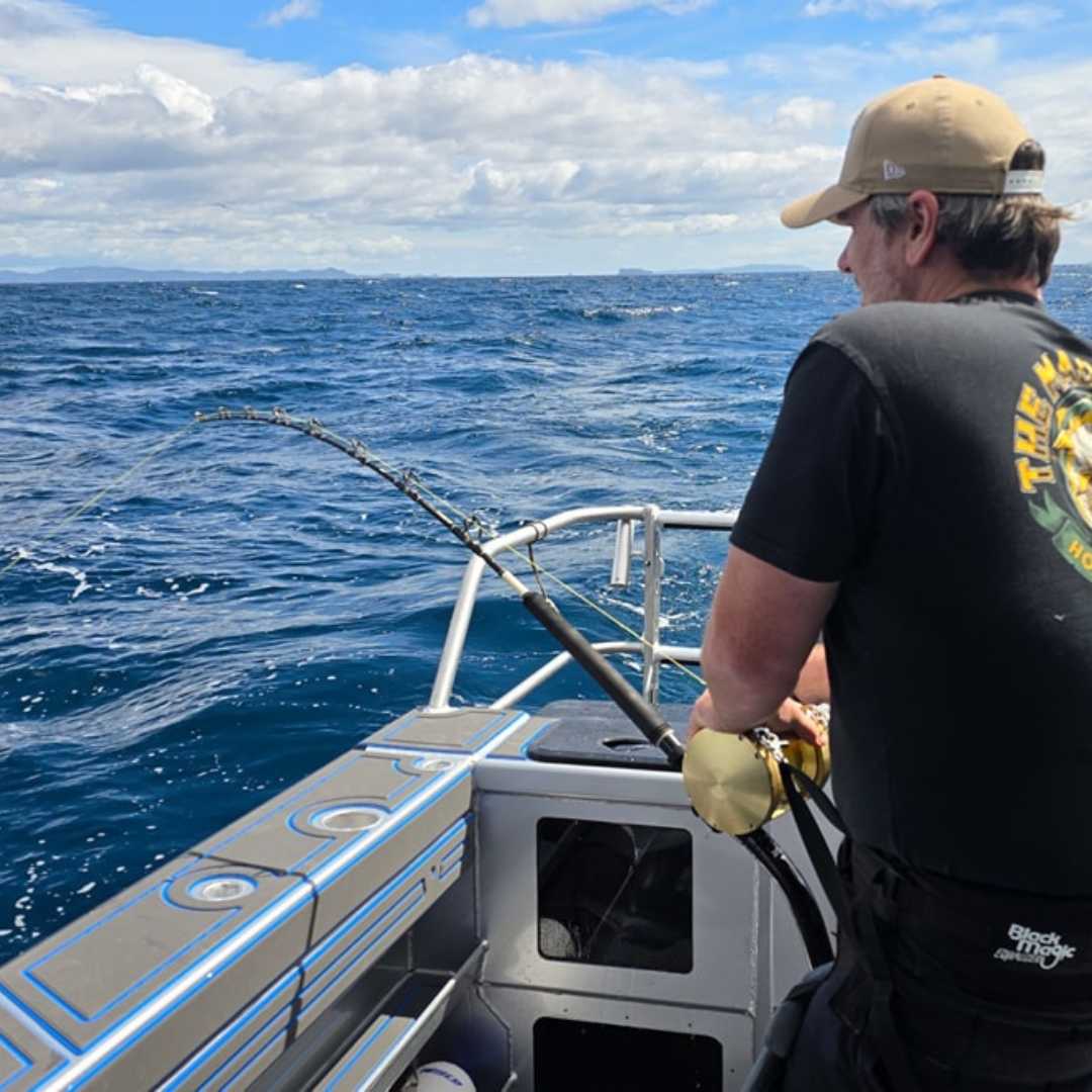two men catching fish at the same time